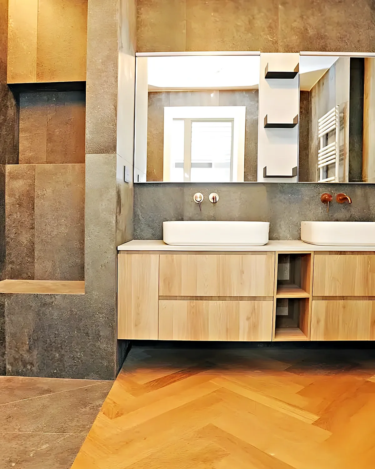 Baño reformado en piedra gris con mueble de madera y doble lavabo en Vilanova i la Geltrú